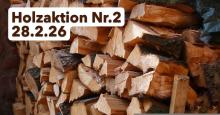 gestapeltes Brennholz mit Textfeld "Holzaktion Nr.2, 28.2.26"